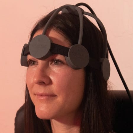 Woman wearing an rTMS machine