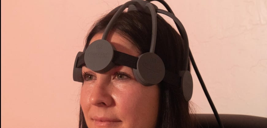 Woman wearing an rTMS machine